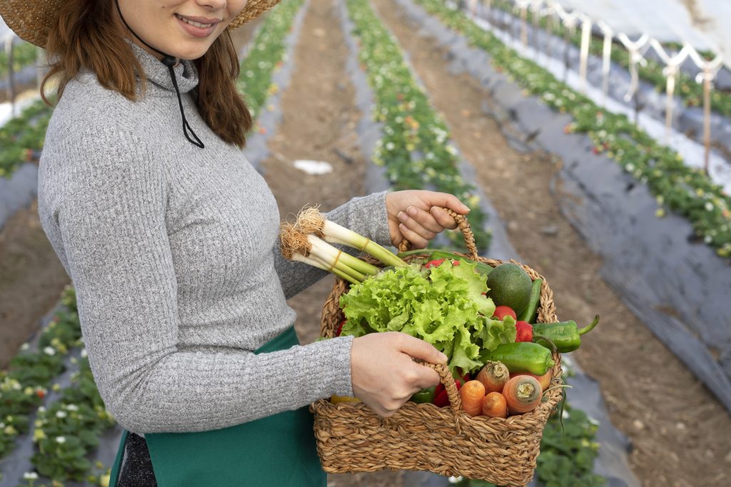 woman holding a basket of vegetables