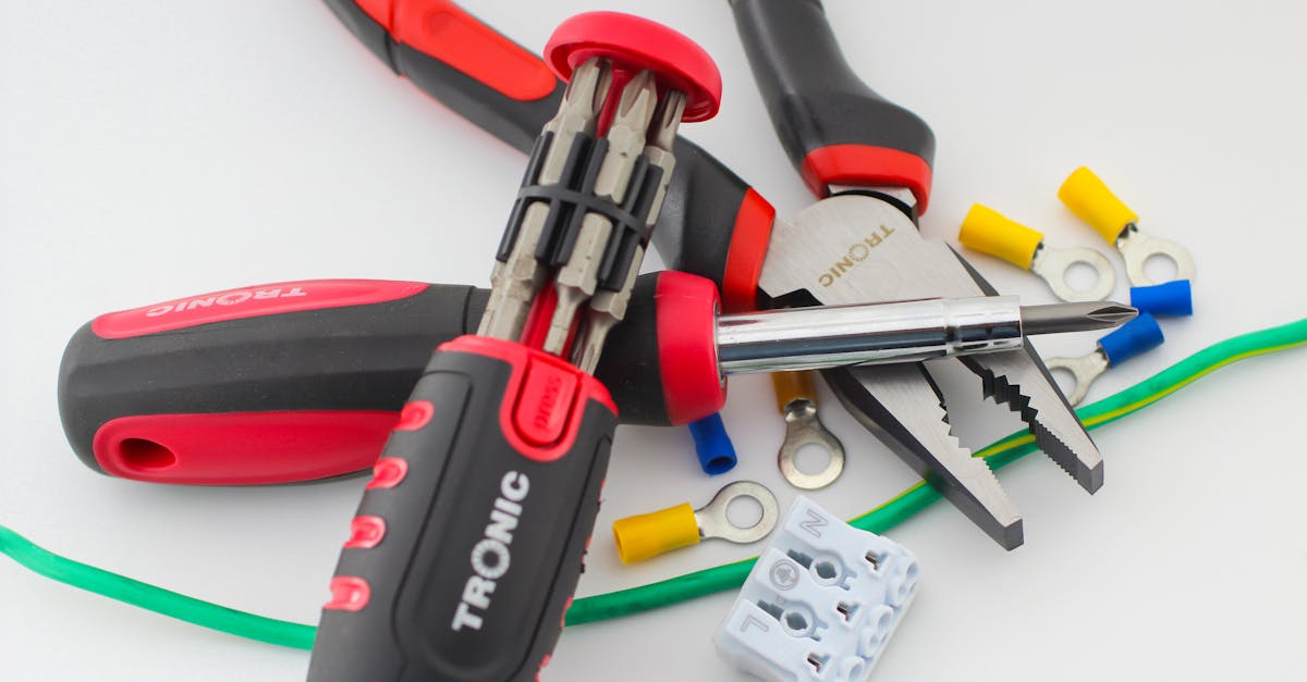 a close up of essential electrical tools on a white surface featuring pliers screwdriver and colo 2