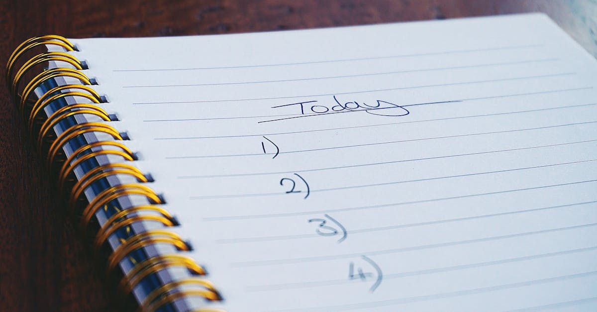 a close up view of a handwritten to do list on a spiral notebook with numbers for tasks