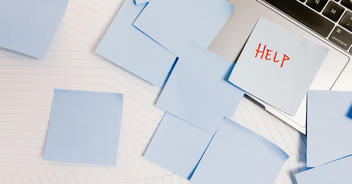 a cluttered workspace with sticky notes on a laptop symbolizing overwhelm and need for help 2