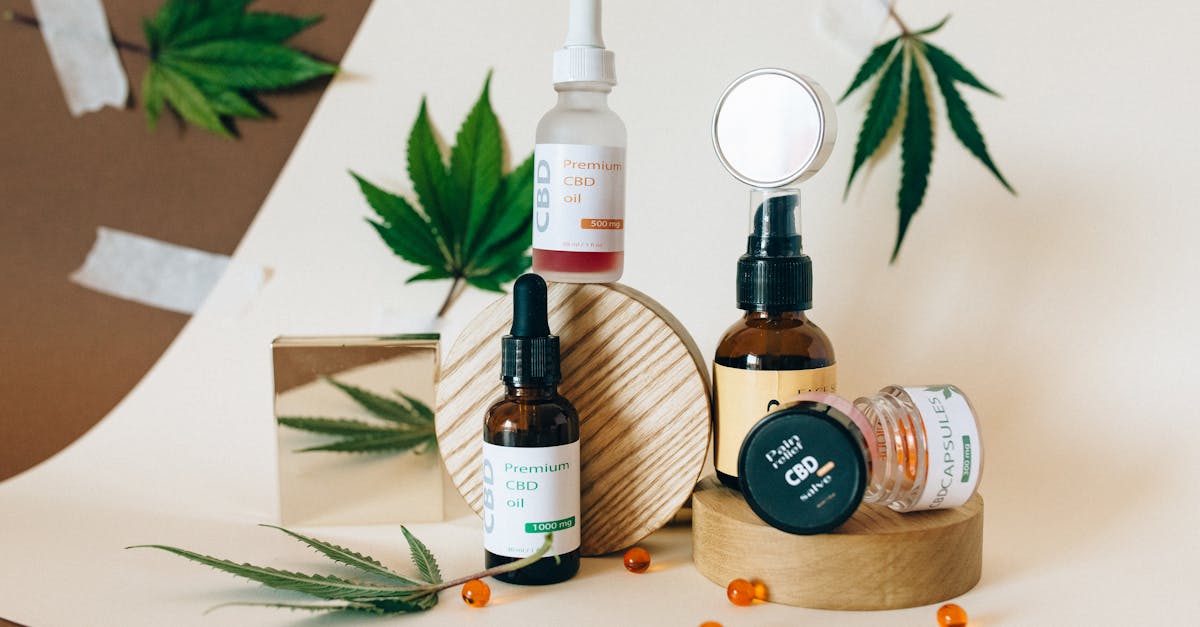 a collection of cbd oil products showcased with cannabis leaves on a neutral background