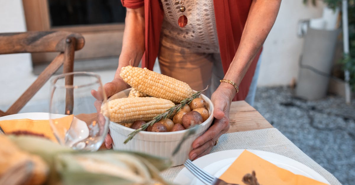 a cozy thanksgiving table setting with corn and potatoes perfect for fall gatherings