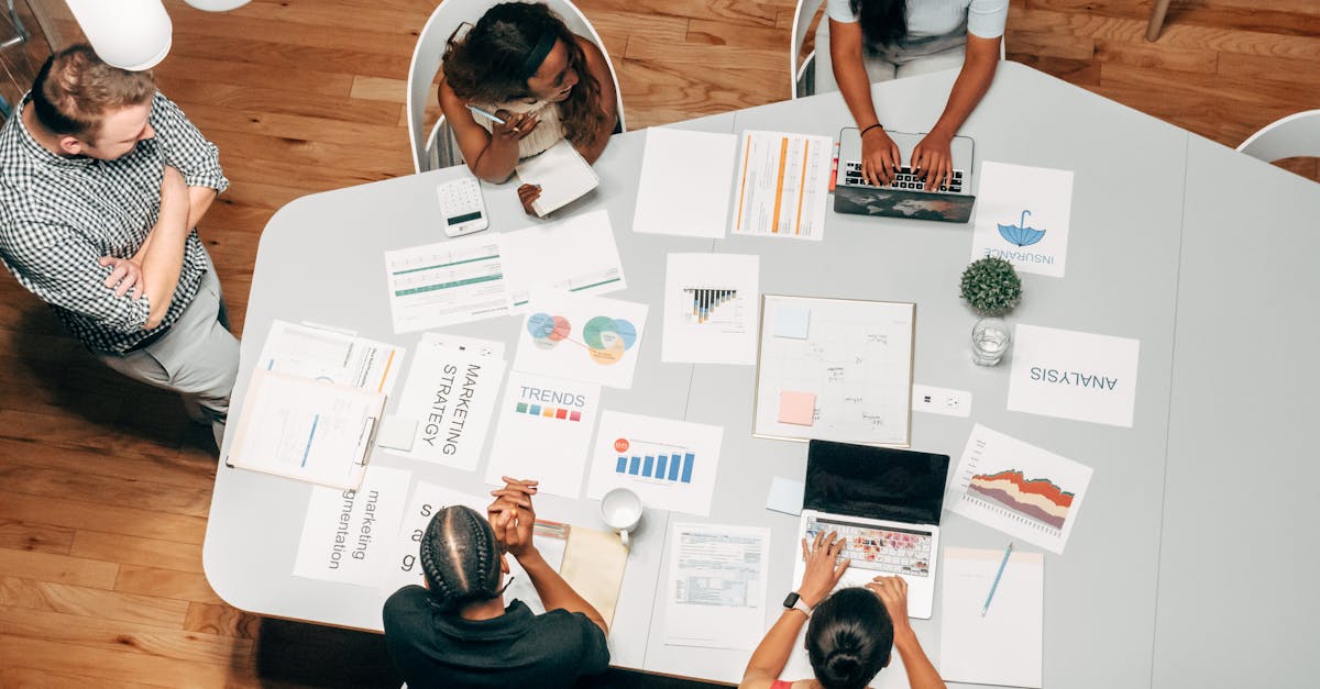 a diverse group working on marketing strategies with charts and laptops in an office setting 2
