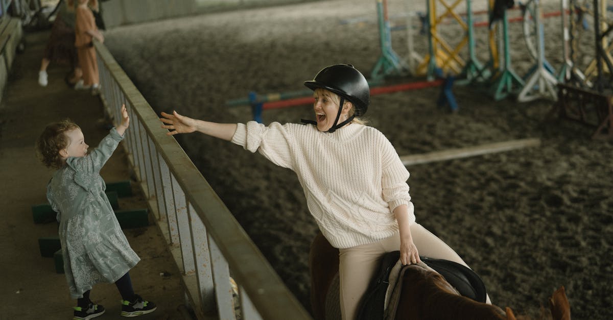 a joyful moment between a mother and child at an indoor horse riding stable embracing connection an