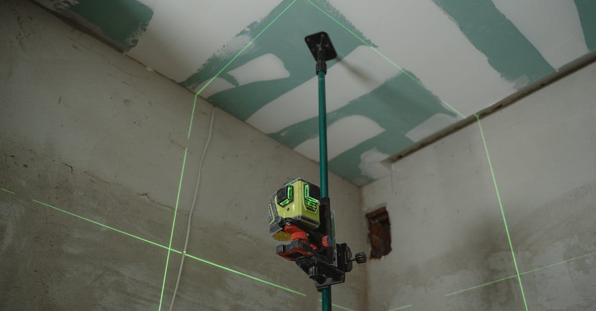 a laser level tool in action at an indoor construction site with marked walls