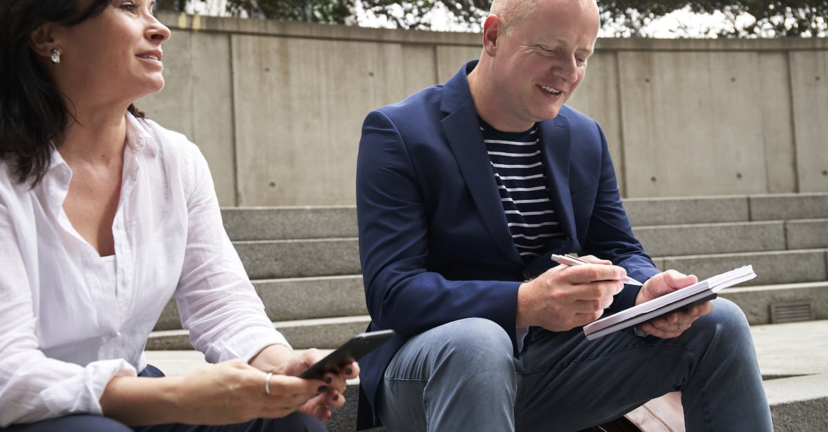 a man and woman engage in a work related discussion outdoors in london 1