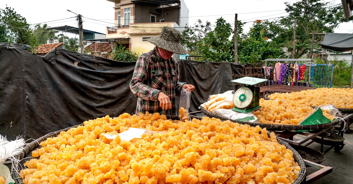 a person packaging freshly made jaggery at an outdoor rural farm setting 3