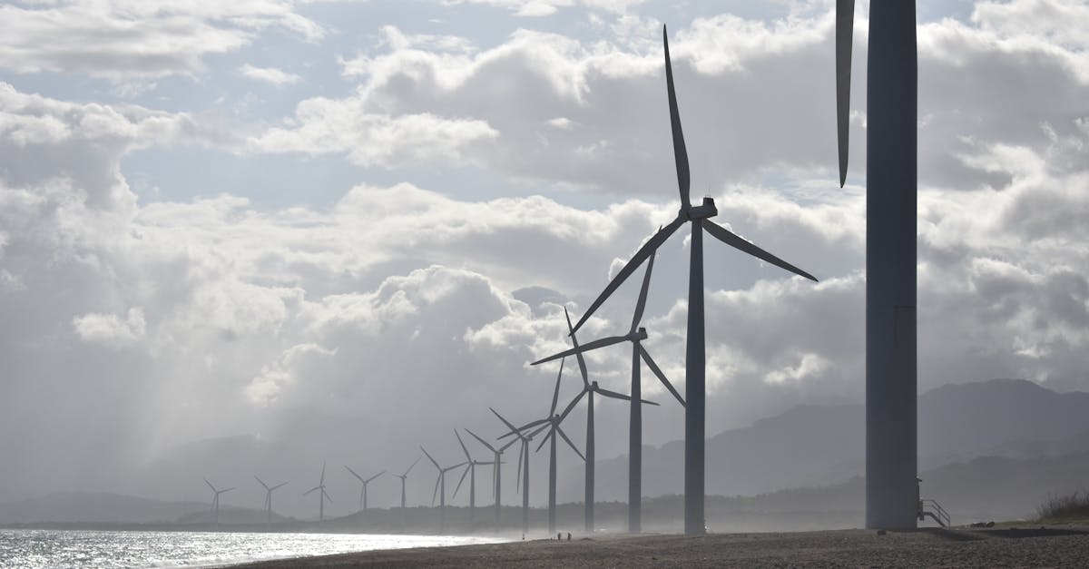 a row of wind turbines along a cloudy beach shoreline in vigan city philippines