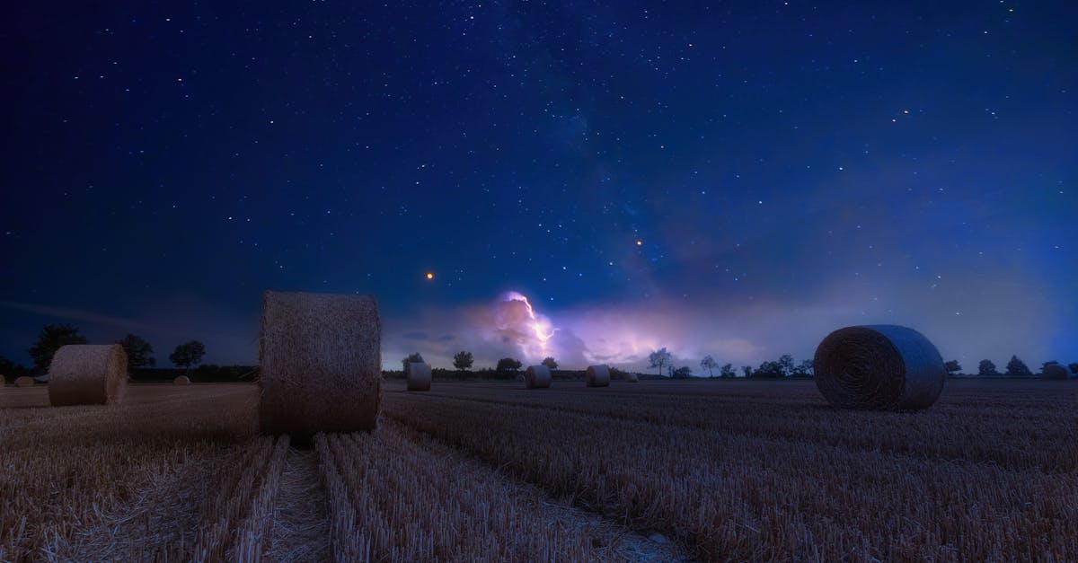 a scenic rural landscape featuring hay bales under a starry night sky perfect for serene and dreamy 4
