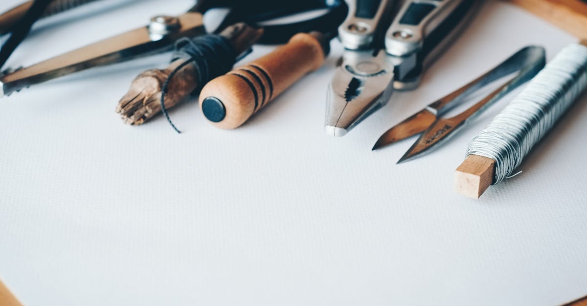 a selection of artisan tools and handmade crafts displayed on a white desk perfect for creative pro 8