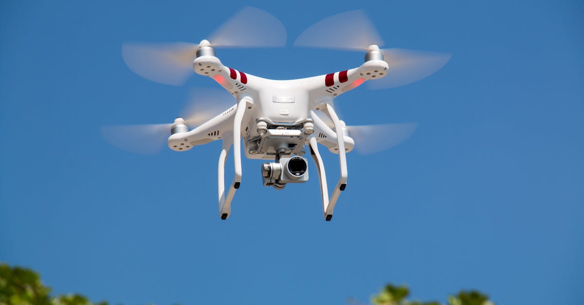 a white drone flying with camera against a clear blue sky in la libertad 1