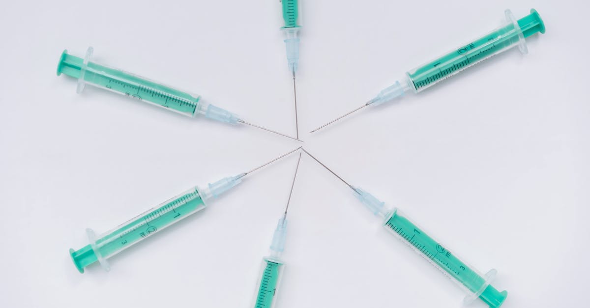 abstract arrangement of medical syringes forming a star pattern on a white surface