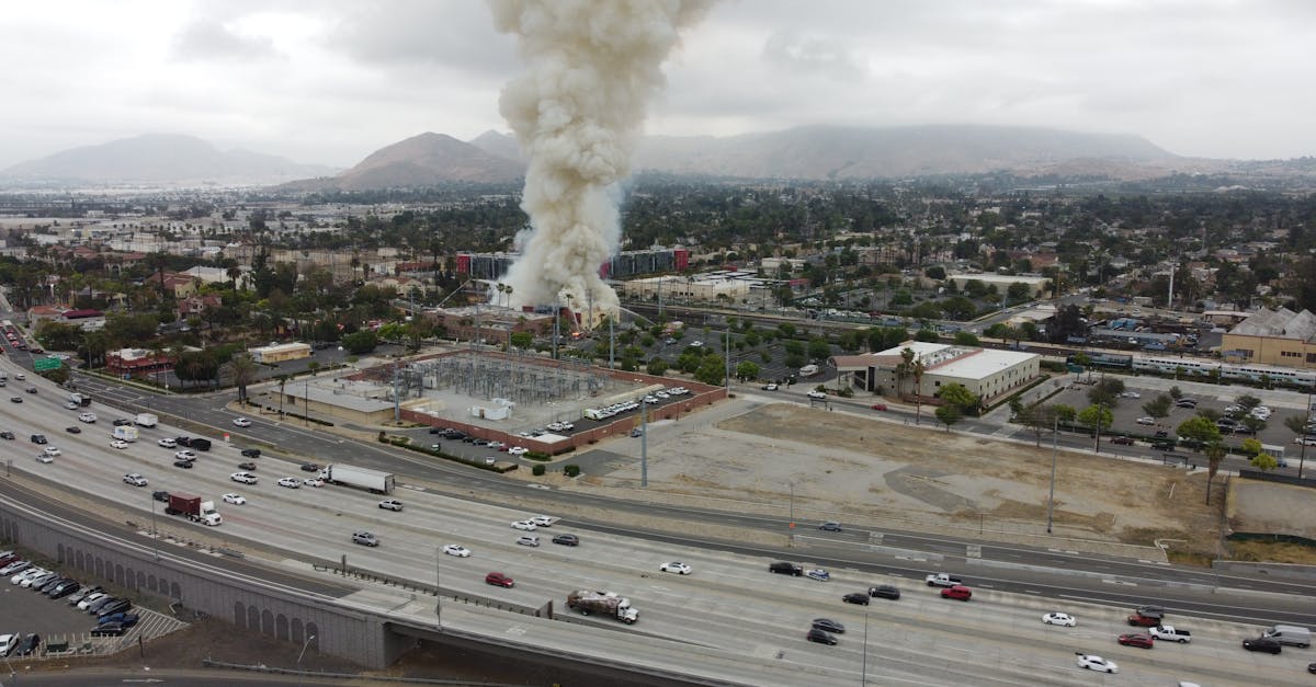 aerial shot capturing dense smoke from a fire in riverside ca with nearby highways and cityscape v