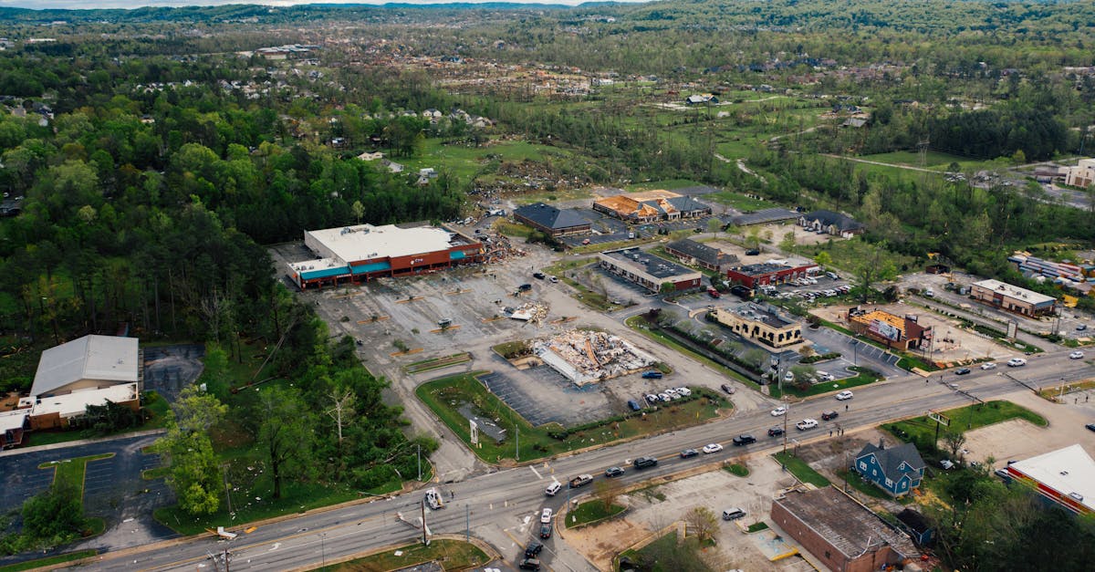 aerial view of small town outpost area with low level commerce buildings surrounded with lush green