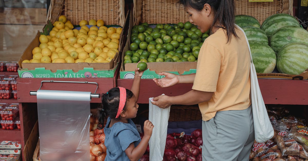 back view asian woman with daughter wearing casual outfits standing near local street market stall a