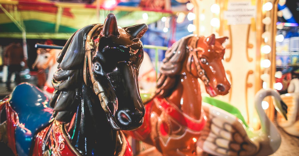 brightly lit carousel horses at a festive night fairground with colorful lights
