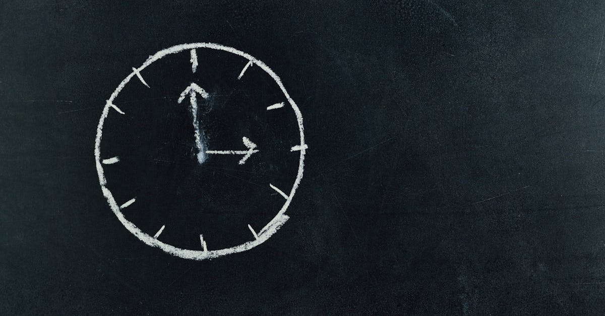 chalk drawn clock on a blackboard symbolizing time and education concepts
