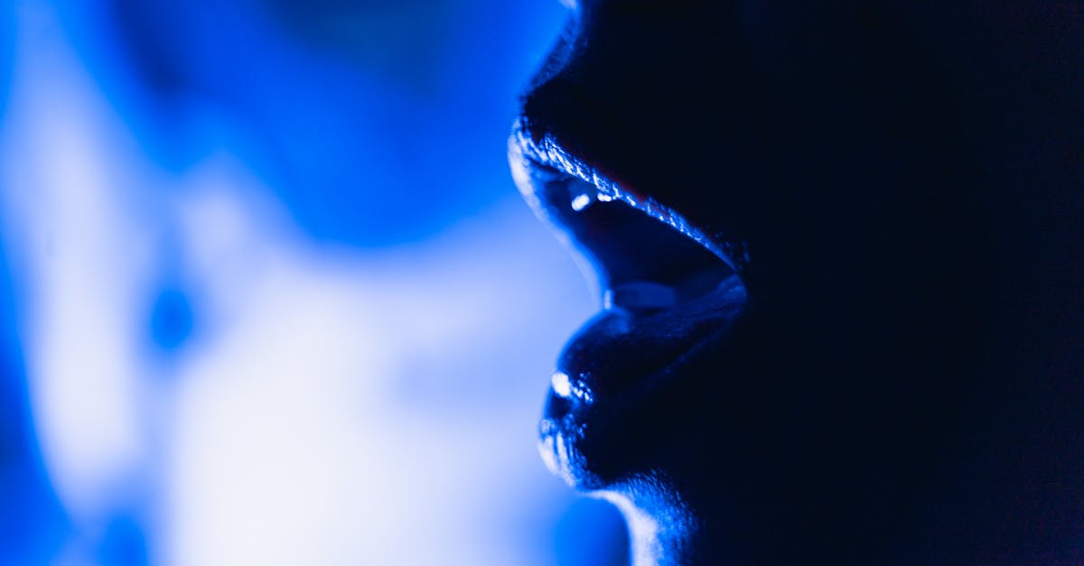 close up abstract image of an open mouth silhouette in dramatic blue lighting