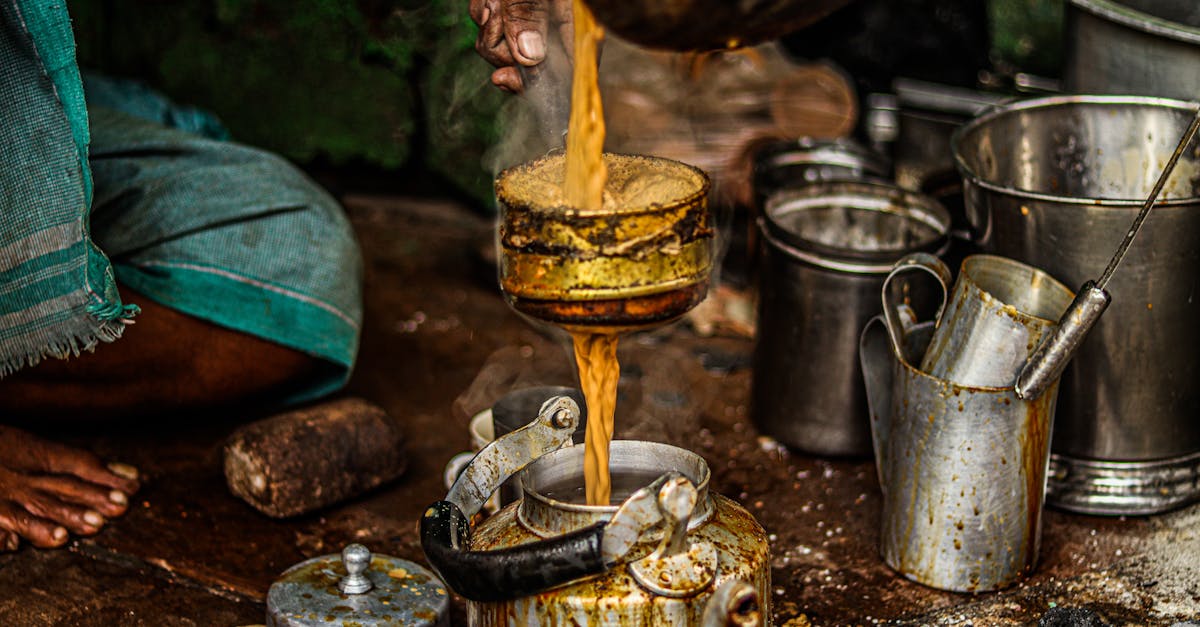 close up of a traditional tea brewing process with rustic utensils and steaming tea