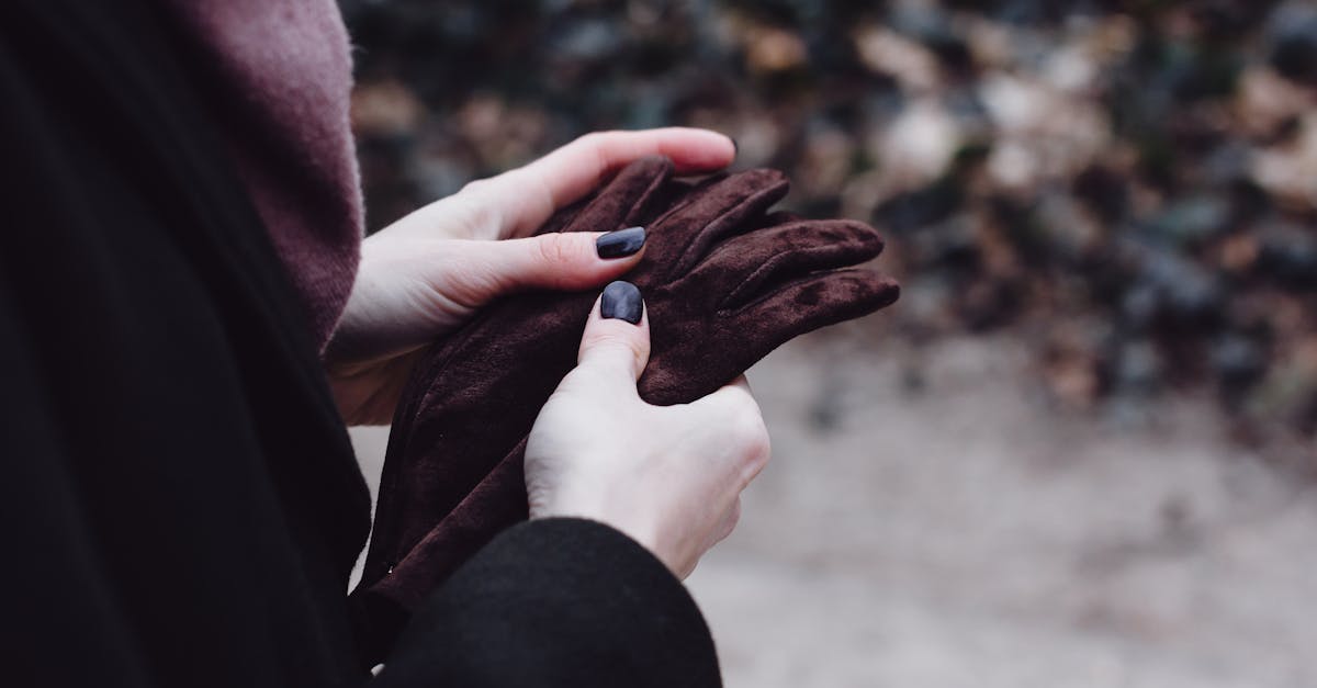 close up of a woman adjusting her warm brown gloves outdoors capturing winter vibes 2