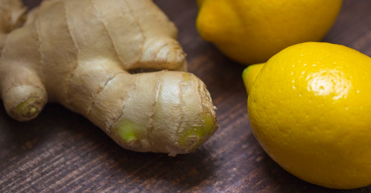close up of fresh ginger root and lemons on a wooden surface showcasing natural ingredients 2