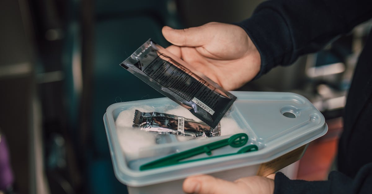 close up of hands holding a first aid kit with medical supplies ideal for health and safety themes