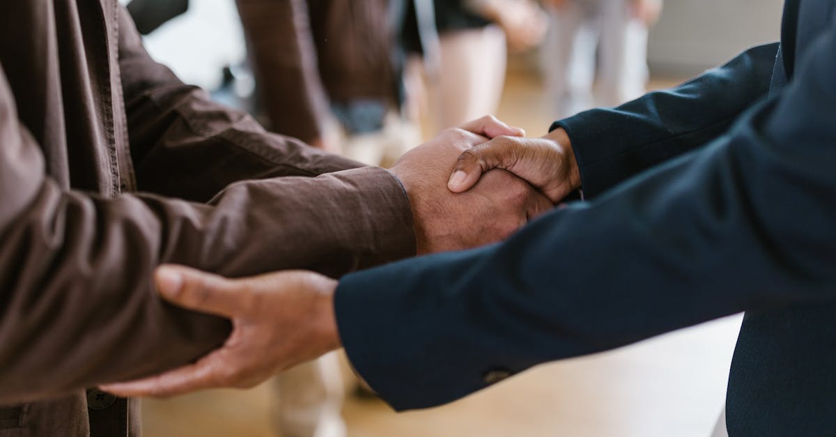 close up of two businesspeople shaking hands symbolizing agreement and partnership