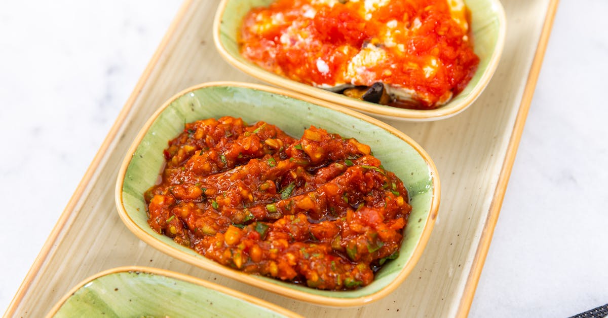 colorful mediterranean dips in ceramic bowls on a wooden tray perfect for food enthusiasts