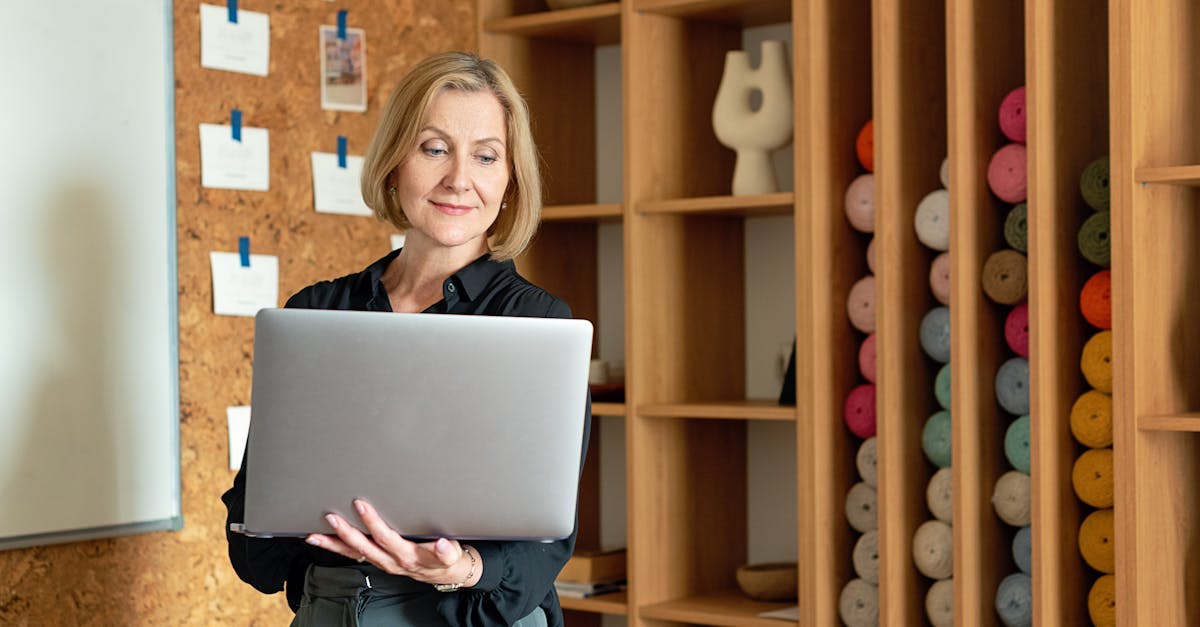 confident businesswoman using a laptop in a creative office setting