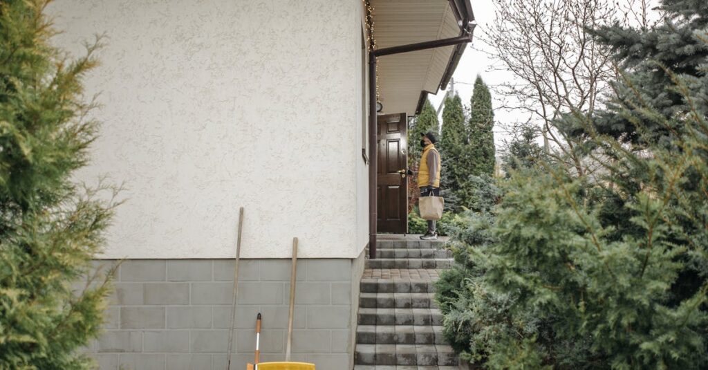 delivery person holding a paper bag standing at a house door surrounded by outdoor greenery