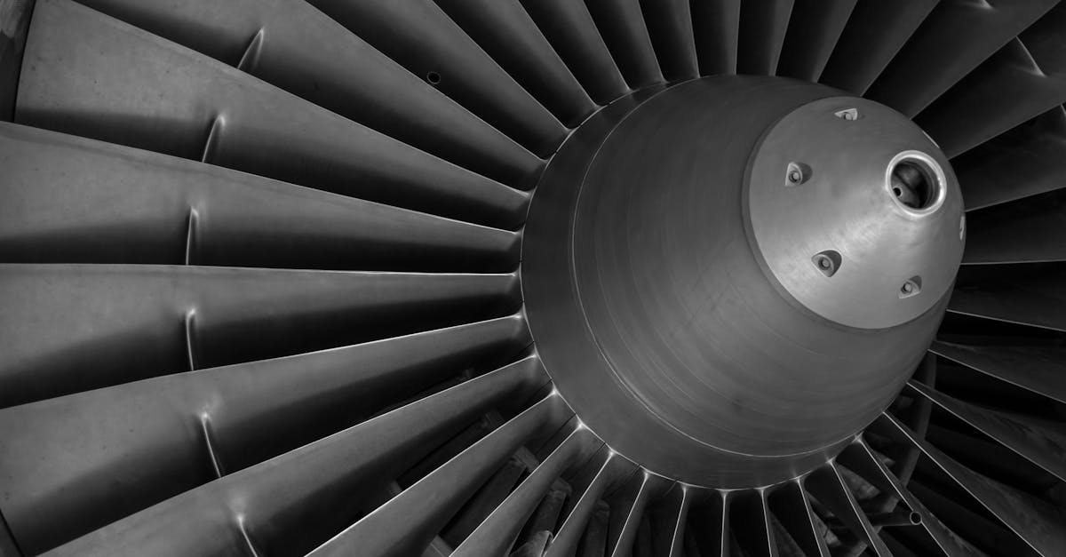 detailed black and white image of an airplane turbine engine showcasing blades and craftsmanship