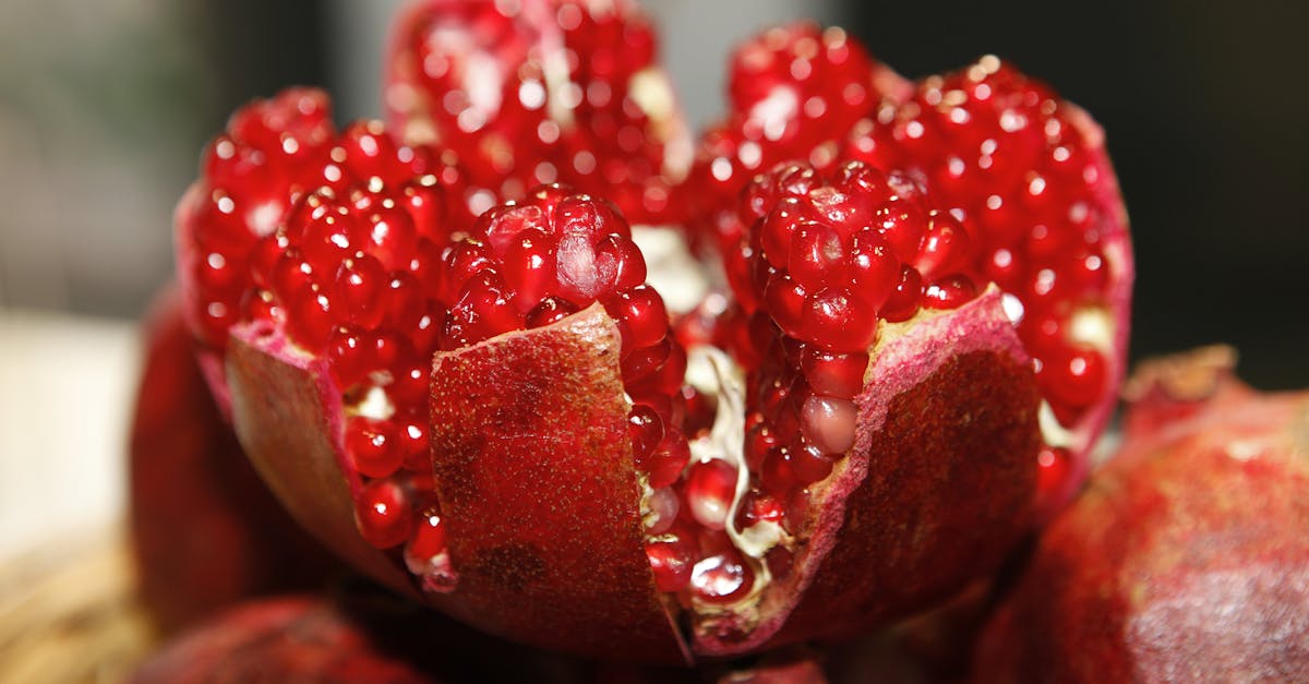 detailed macro shot of a fresh vibrant pomegranate exposing its juicy seeds 2