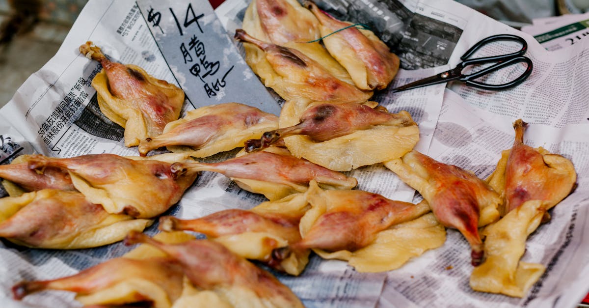 dried poultry on newspapers ready for sale with scissors nearby 3