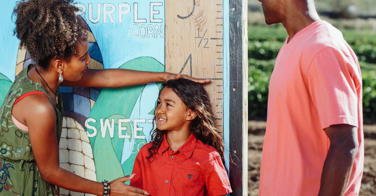 family enjoys a sunny day measuring child s height at a corn field 4