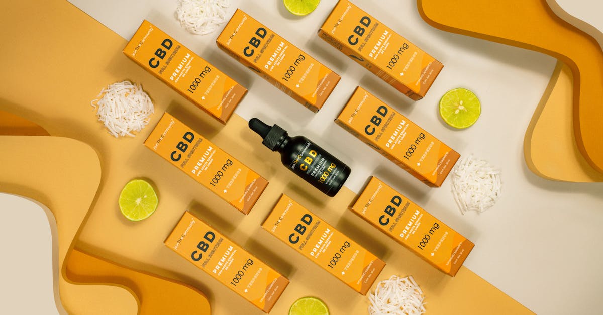 flat lay of cbd oil boxes with lime slices and abstract yellow background shot in mexico city