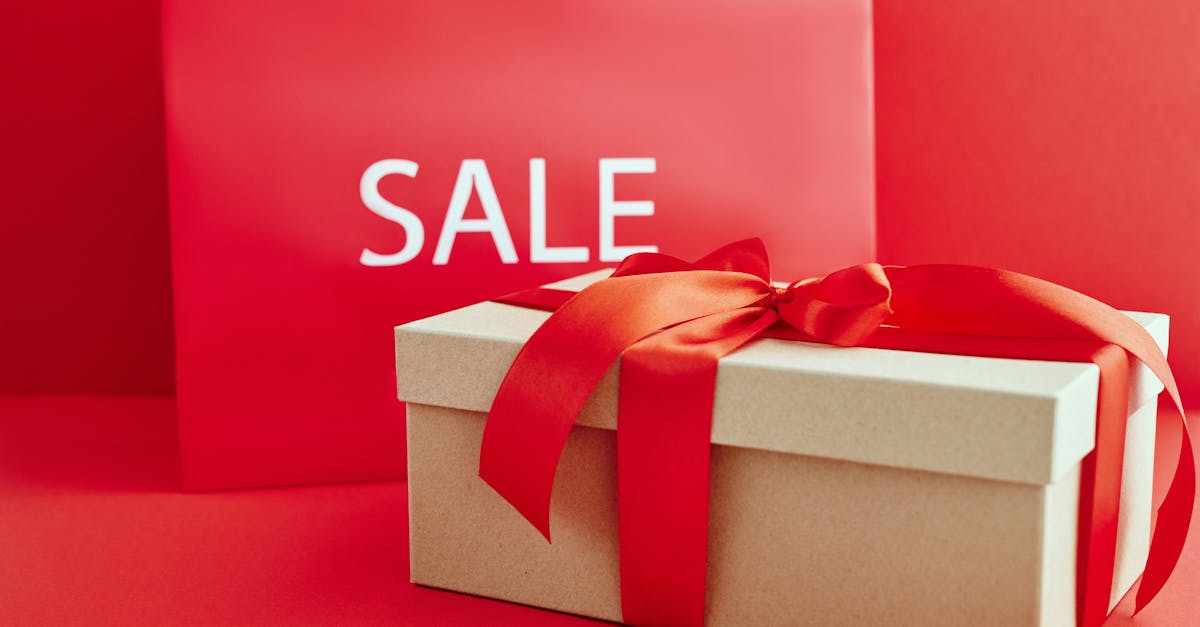 gift box with red ribbon on red background with sale sign perfect for retail promotions