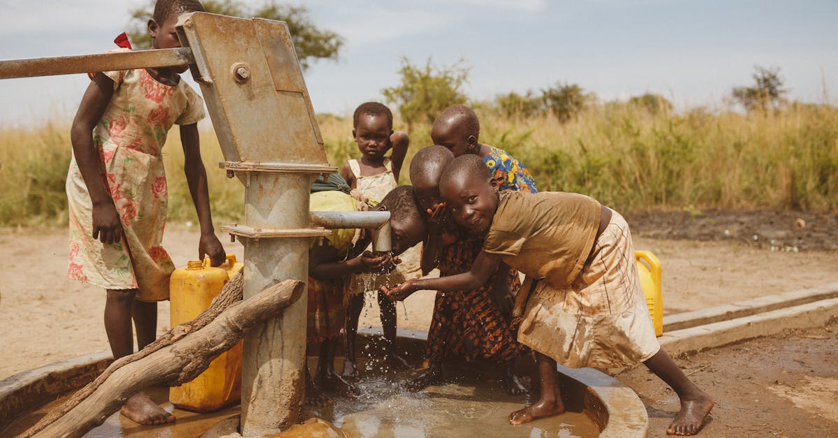 group of children gathering water from a well in kitgum uganda 3