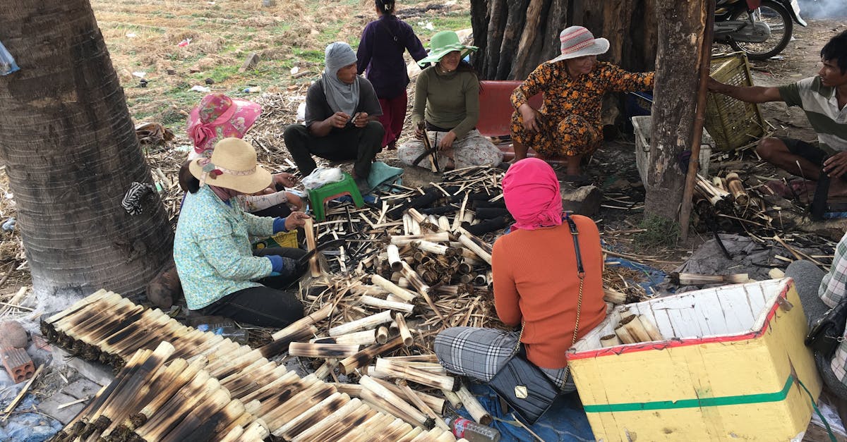 group of people crafting bamboo products outdoors showcasing local culture and community effort