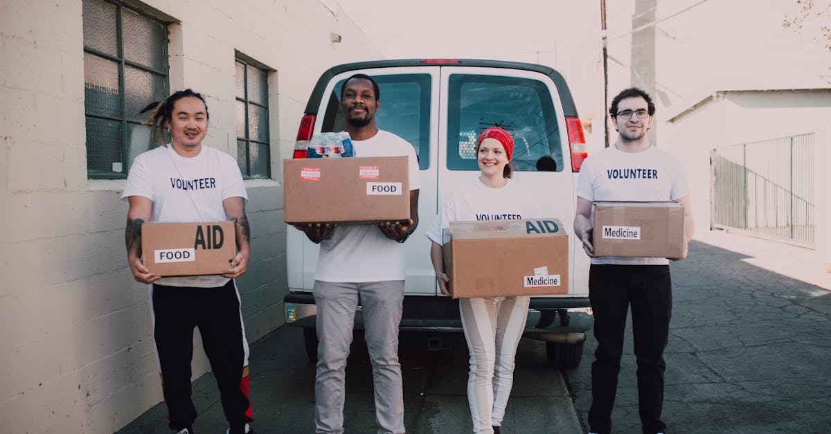 group of volunteers holding aid boxes ready to distribute in the community