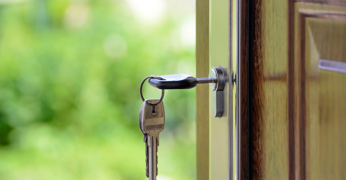 key inserted in door lock against a blurred green background symbolizing security and real estate 1