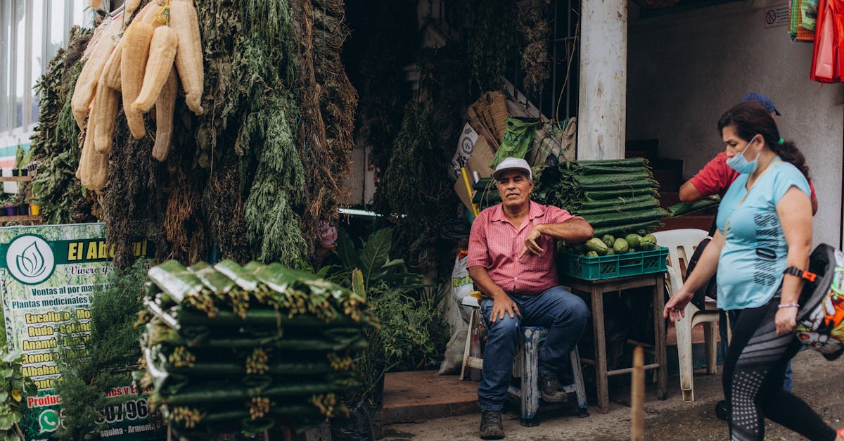 local vendors selling fresh herbs and produce at an outdoor market stall