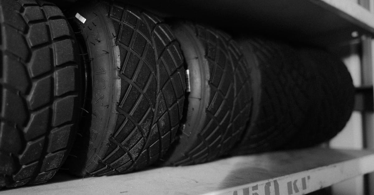 monochrome photo of multiple tires arranged neatly on a shelf in a close up shot 2