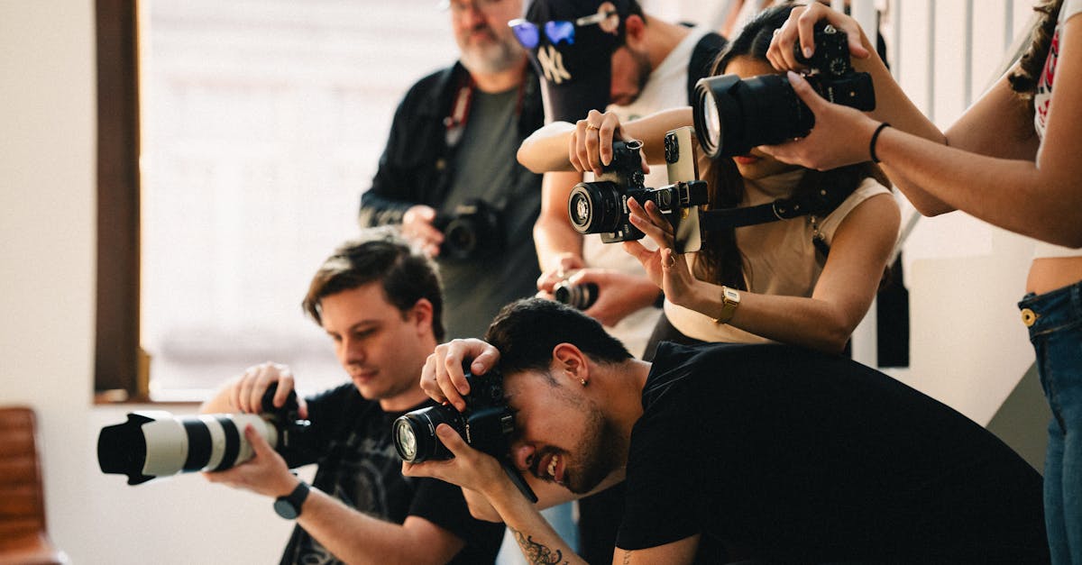 multiple photographers with cameras taking shots indoors team of diverse ages and genders