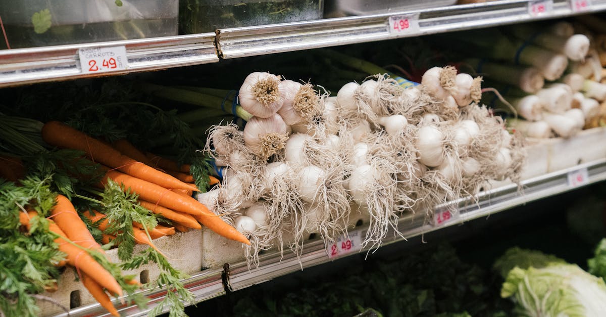 organic carrots and garlic neatly arranged on supermarket shelf showcasing freshness