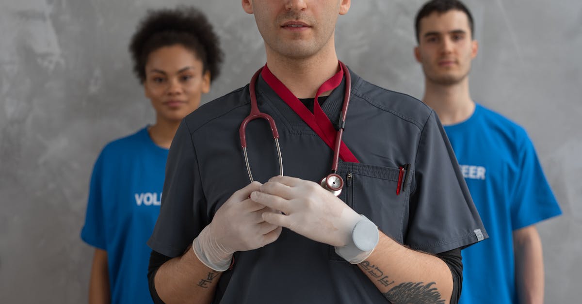 portrait of a healthcare professional with volunteers in blue shirts showing teamwork 1