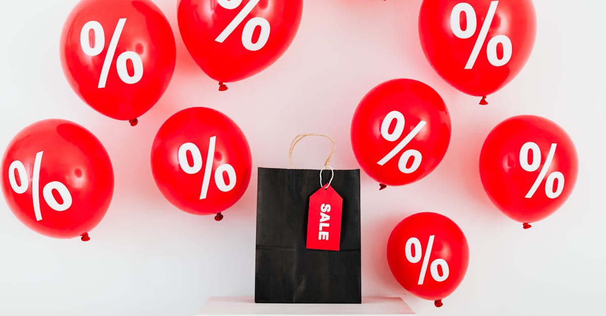 red balloons with percentages and a black sale bag on a white background 1