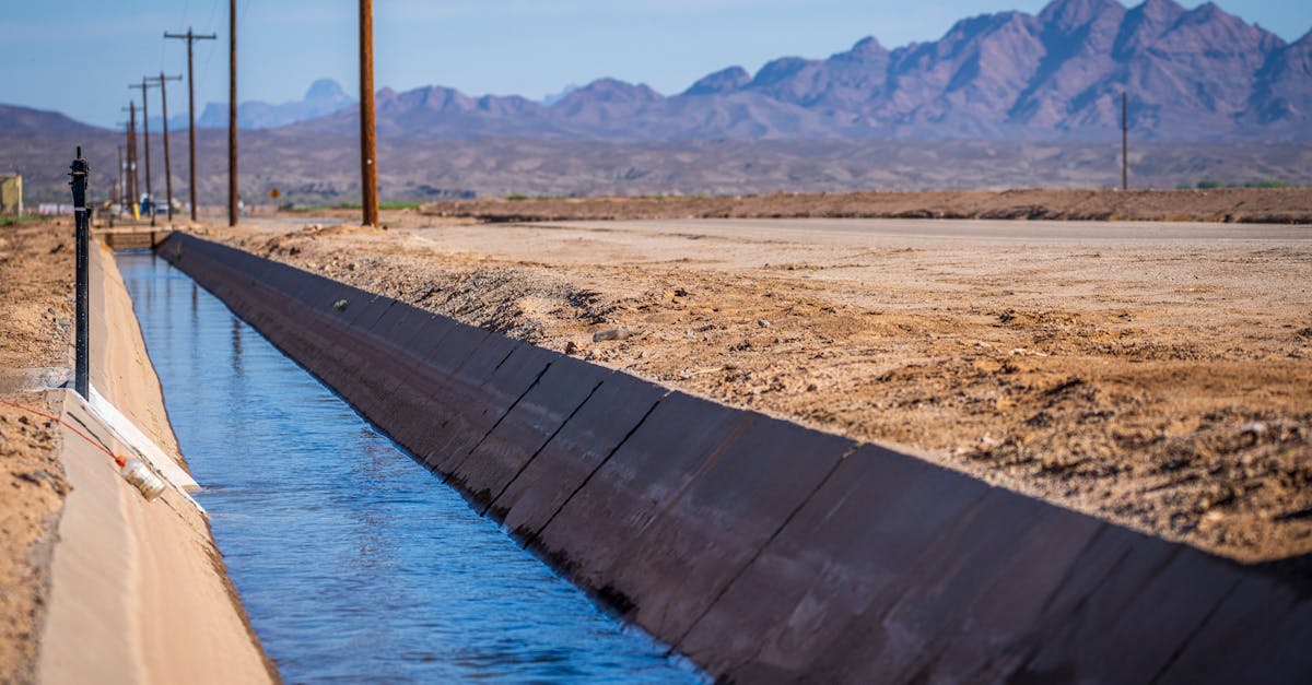 serene canal in yuma arizona with desert mountains in the background