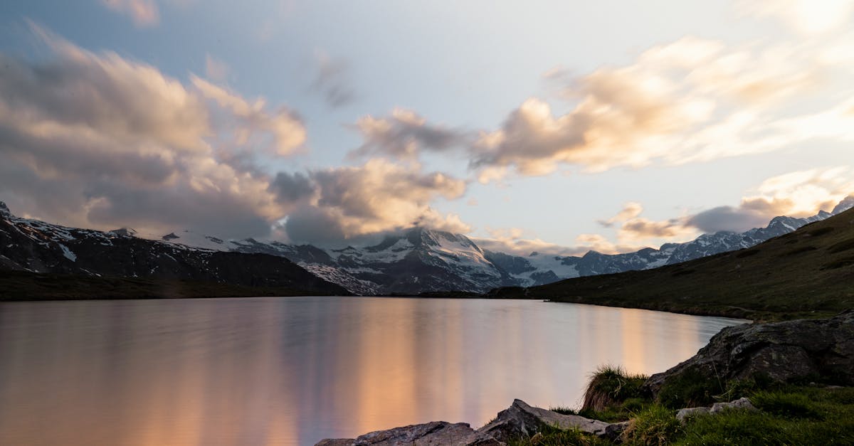 serene view of zermatt s lake and snow capped mountains during sunset peaceful and picturesque land