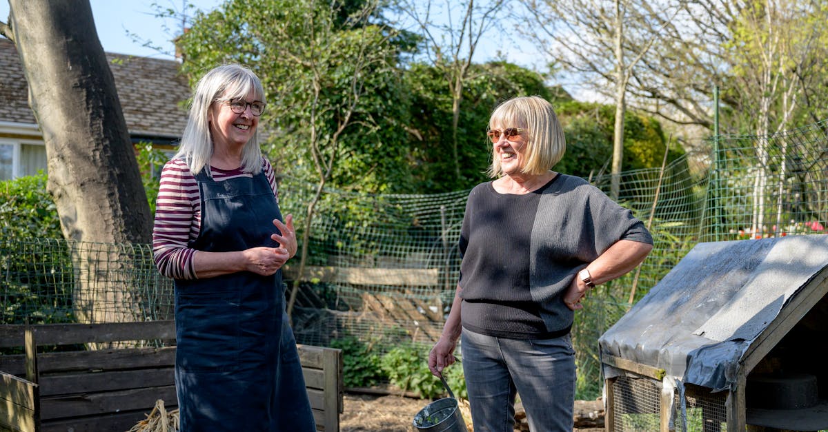 smiling senior women enjoying gardening in a sunny backyard garden setting