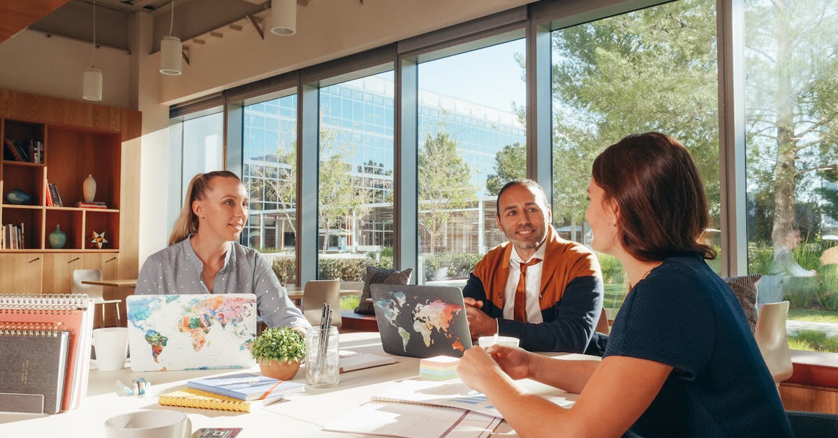 three diverse professionals collaborate in a bright modern workspace